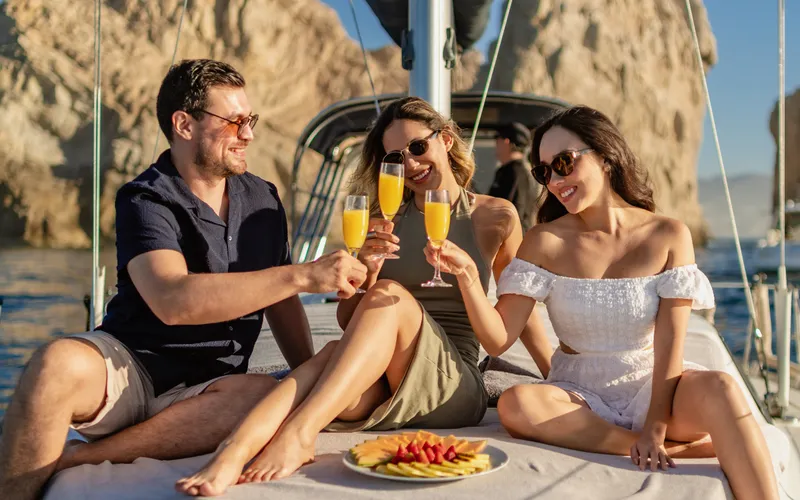 Guests toasting at sunset near El Arco