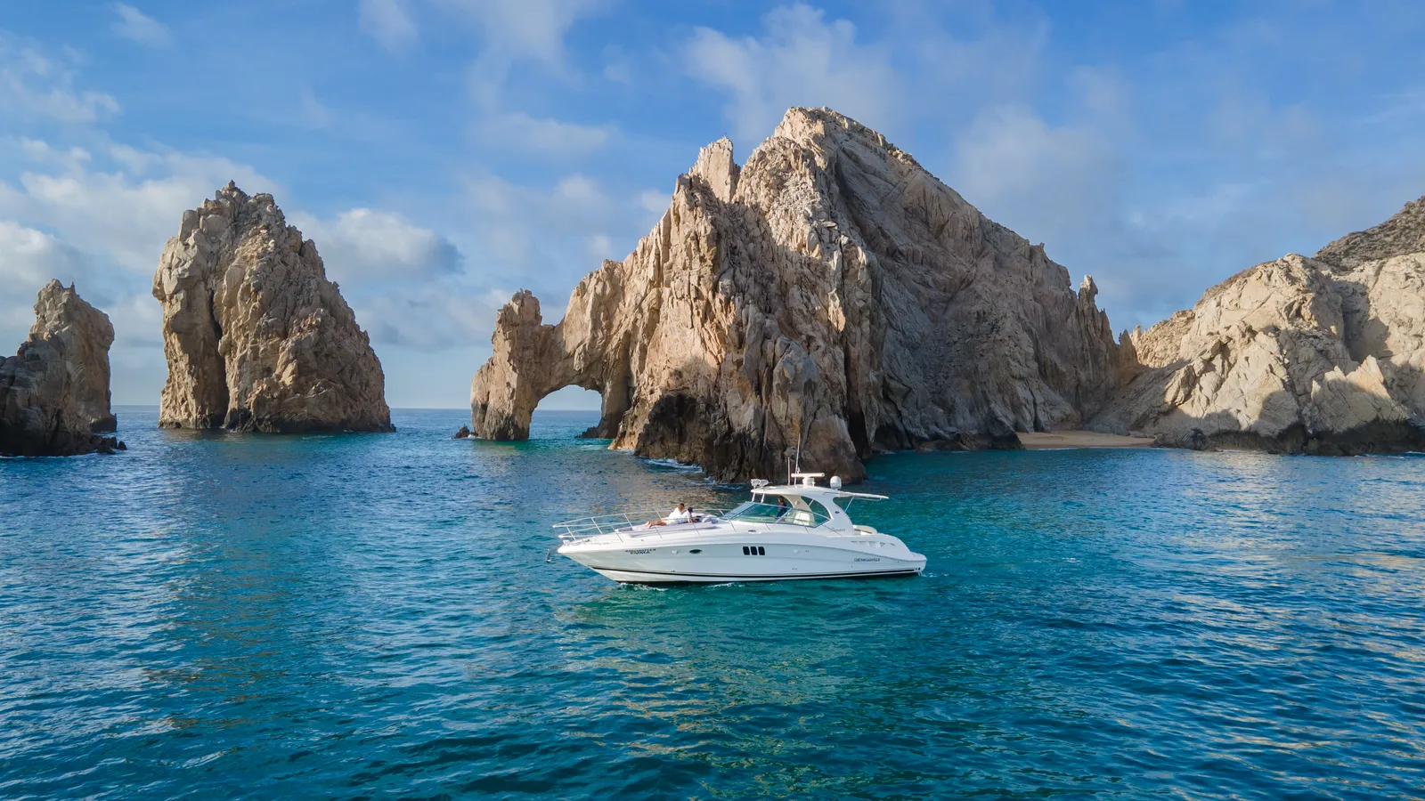Luxury private yacht charter cruising past the Arch of Cabo San Lucas