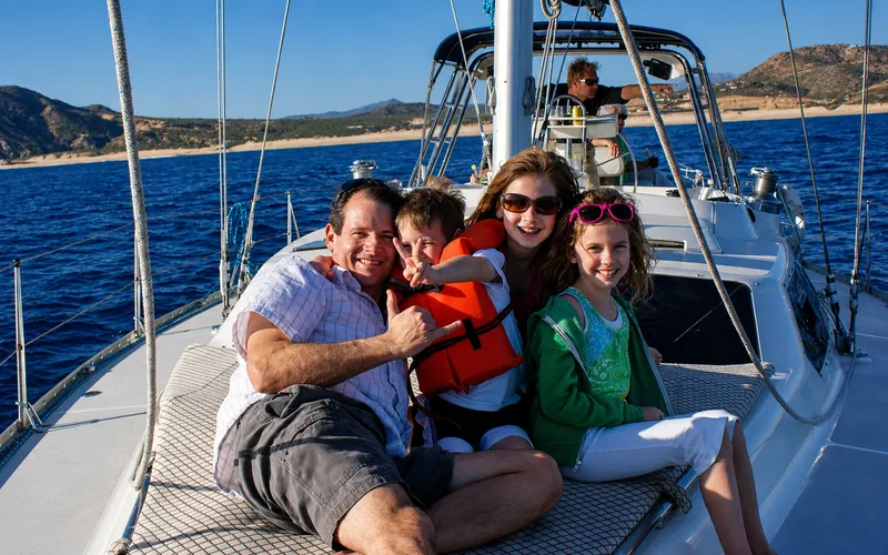 Family having fun on a sunny sailboat